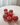 Charming ceramic tomato candle holders on a white table, perfect for dining decor and Spanish craftsmanship.