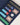 Detailed view of blue leather poker case interior with colorful chips, cards, and branded dealer button.